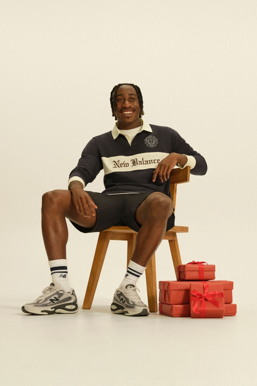 Man sitting on chair in new balance AC runners